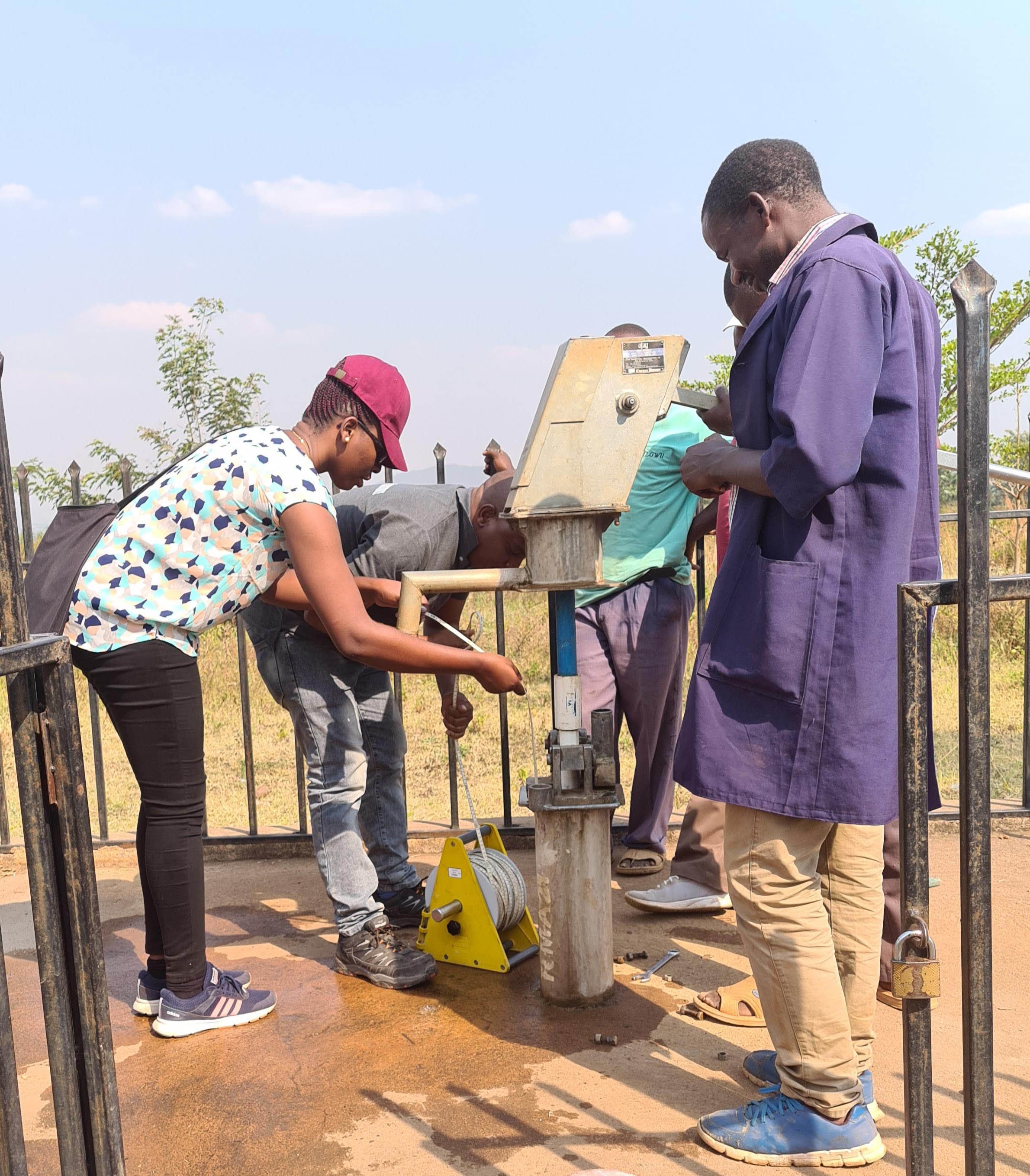 Dr Augustina Alexander measures groundwater levels during a field survey with colleagues from the Rufiji River Basin office.