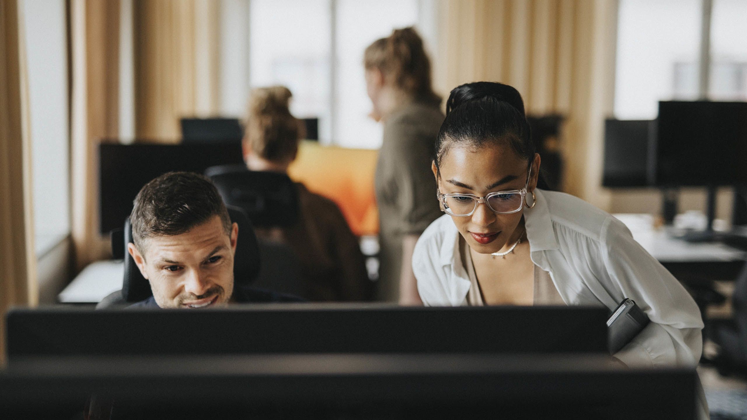 man and woman collaborating at a computer: Source: Maskot/Maskot via Getty Images