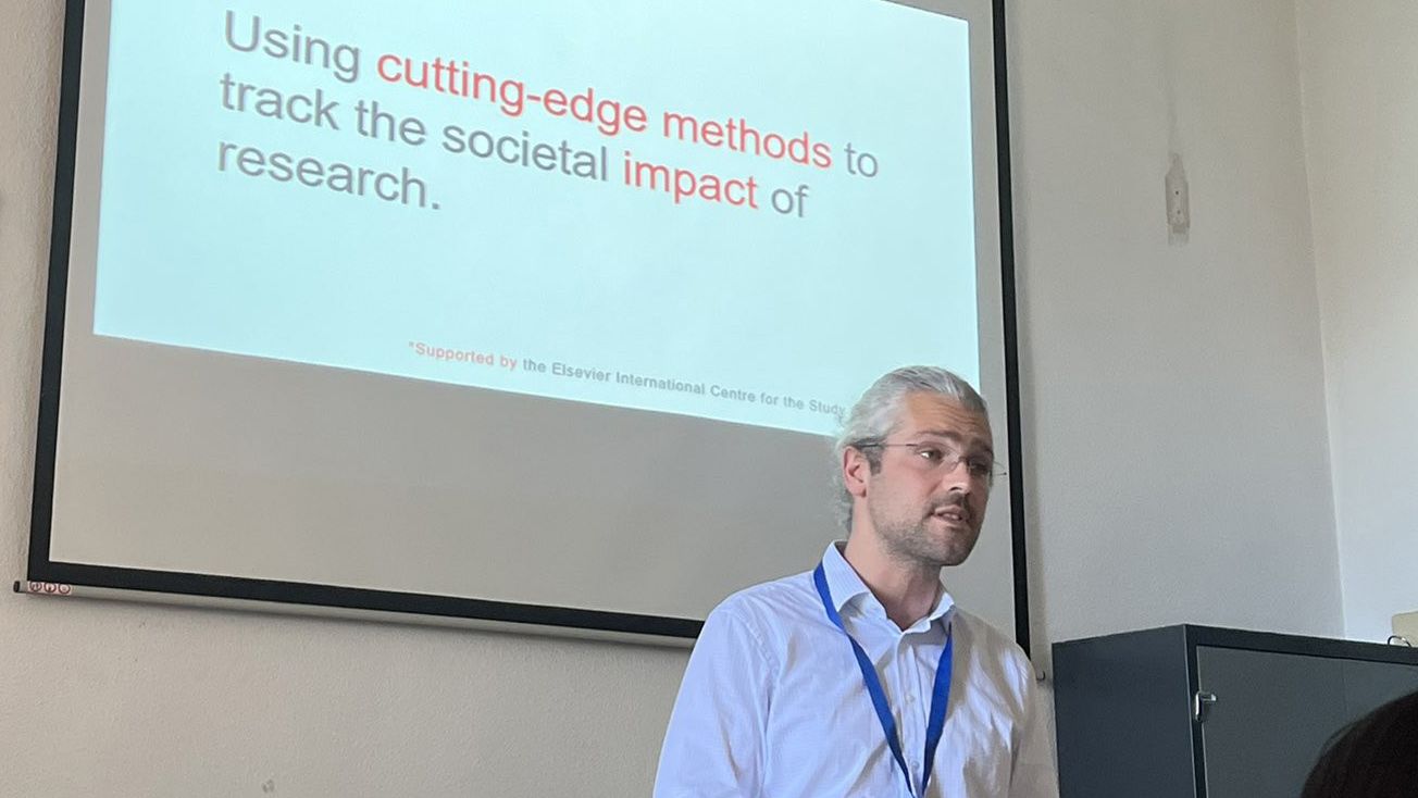 Researcher Basil Mahfouz gives a presentation on "using cutting-edge methods to track the societal impact of research."